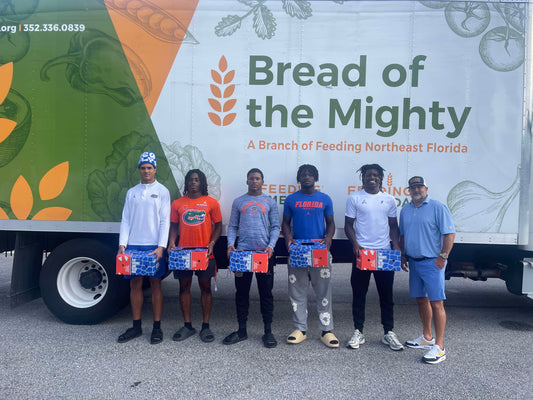 Florida Gator Football players in front of the Bread of the Mighty food bank truck following their fundraiser with Front Door Produce
